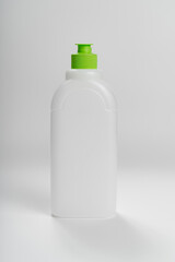 white plastic bottle with a green cork on a white background. recycling plastic.
