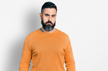 Hispanic man with beard wearing casual winter sweater depressed and worry for distress, crying...