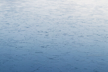 Winter background of ice on the river with a light texture