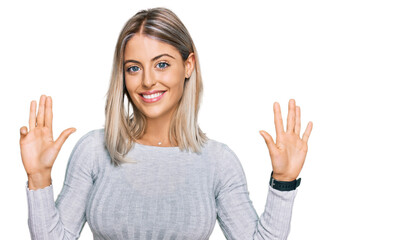 Beautiful blonde woman wearing casual clothes showing and pointing up with fingers number nine...