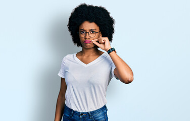 Young african american woman wearing casual white t shirt mouth and lips shut as zip with fingers....