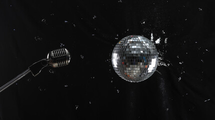 disco ball and microphone on black background