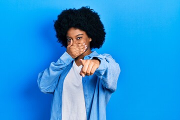 Fototapeta na wymiar Young african american woman wearing casual clothes laughing at you, pointing finger to the camera with hand over mouth, shame expression