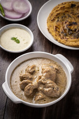 cream chicken curry with flatbread chapati or parantha