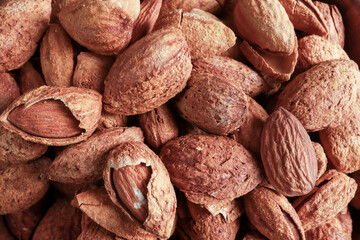 Top view of Almonds are unpeeled and some peeled for background or wallpaper. Healthy foods concept.