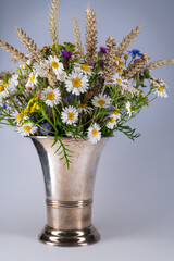 Colorful bouquet of bright wild flowers  in silver vase.White background.Vintage Home Decor.