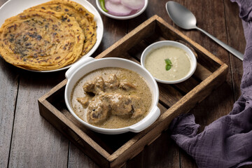 cream chicken curry with flatbread chapati or parantha