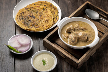 cream chicken curry with flatbread chapati or parantha