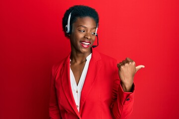 Young african american girl wearing call center agent headset smiling with happy face looking and...