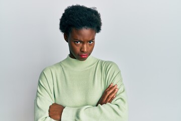 Young african american girl wearing casual clothes skeptic and nervous, disapproving expression on face with crossed arms. negative person.