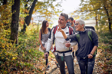 An elderly couple at hiking exploring beautiful sight