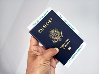 COVID-19 Vaccination Record card, Passport of USA, Immune passport or certificate for travel concept. 