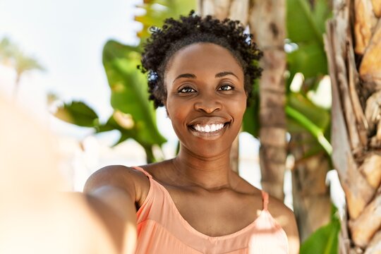 Young african american woman smiling happy on a summer day taking a selfie picture