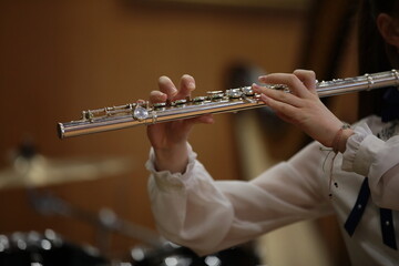 Girl Playing Flute In Concert. Musical Instrument Hands Fingers Isolated © Nina