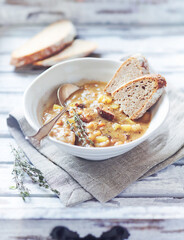 Pea soup on bright wooden background.