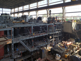 The workshop of an old factory with disassembled outdated technological equipment. Technical re-equipment. Introduction of achievements of scientific and technological progress. 