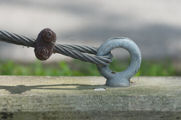 anchor with guy strand wire bolted to a concrete pier