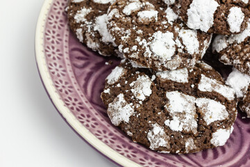 heap of chewy chocolate crinkle cookies with confectioners sugar