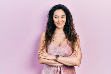Young hispanic woman wearing casual clothes happy face smiling with crossed arms looking at the camera. positive person.