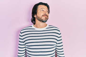 Fototapeta premium Middle age caucasian man wearing casual clothes smiling looking to the side and staring away thinking.