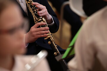 Fototapeta premium Hands Of A Young Musician On The Clarinet Close-Up. Band And School Orchestra Of Students