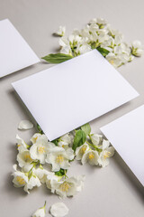 Romantic congratulation postcard with attached natural fresh jasmine  flowers on a gray background, copy space