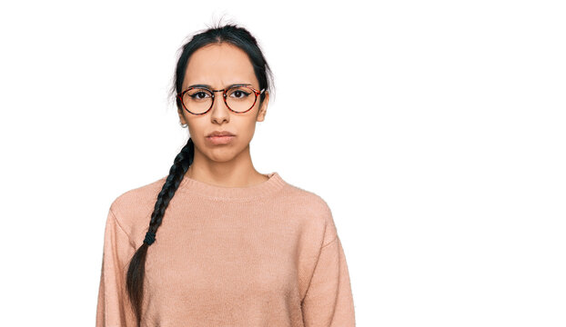 Young hispanic girl wearing casual clothes and glasses depressed and worry for distress, crying angry and afraid. sad expression.