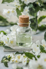Obraz na płótnie Canvas Jasmine essential oil and fresh jasmine blossom. Alternative medicine and natural body care cosmetics. Fresh buds of white flowers.