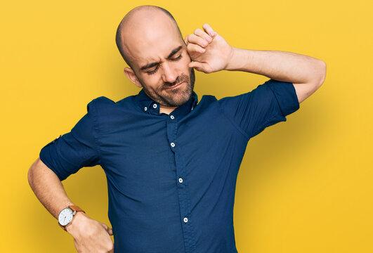 Young hispanic man wearing casual clothes stretching back, tired and relaxed, sleepy and yawning for early morning