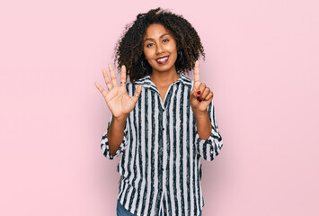 Young african american girl wearing casual clothes showing and pointing up with fingers number six while smiling confident and happy.