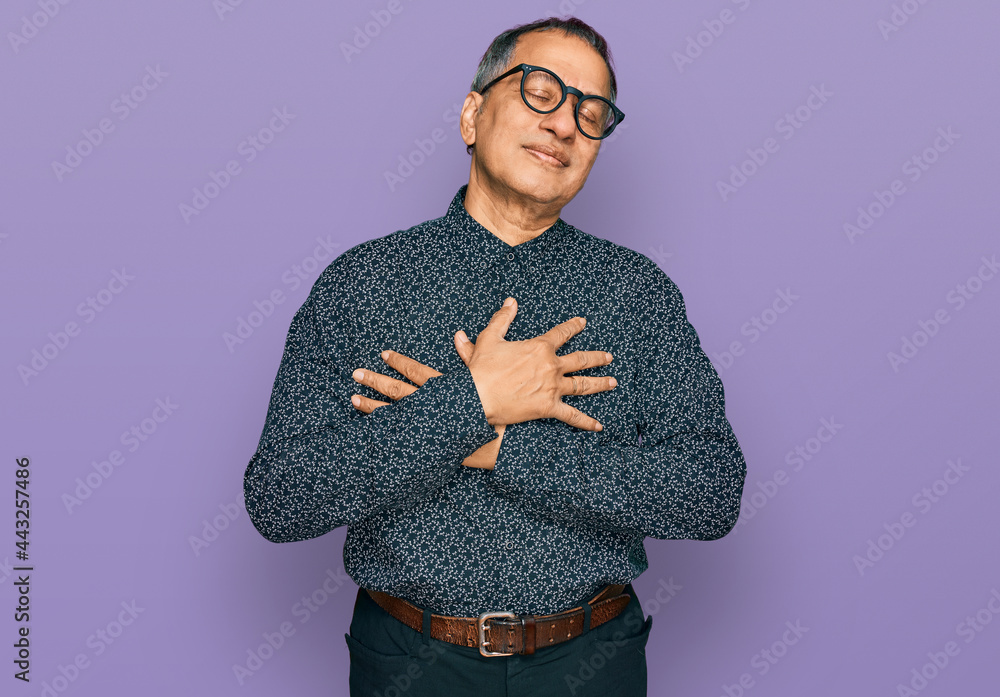 Canvas Prints middle age indian man wearing casual clothes and glasses smiling with hands on chest with closed eye