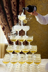 Crystal glasses for holiday, a lot of glasses for guests. Slide pyramid of glasses.