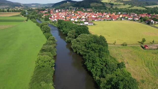 The landscape of the Werra Valley with the Werra River and agriculture fields at Herleshausen in Hesse and Thuringia