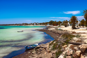 Wonderful views of the Mediterranean coast with birch water, white sand beach and a fishing boat