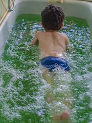 a little boy in a therapeutic bath