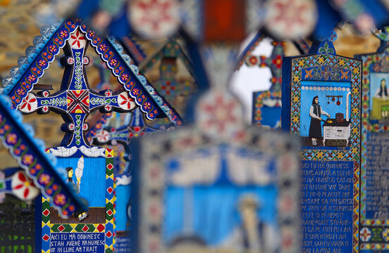 Blue painted wooden crosses in the Merry Cemetery in Maramures, an unique and amusing monument in the entire world