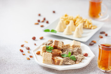 Oriental sweetness.  Nougat, halva and  tea on a table.