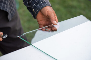 a construction worker is using glass cutting tools