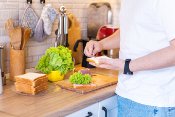 man making sandwich on the kitchen