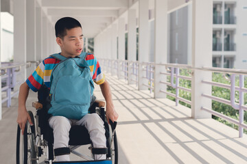 Confident Asian disabled teen boy on wheelchair determining to use wheelchair by himself, Lifestyle in the education age of special need kid, Muscle and self-esteem development concept.