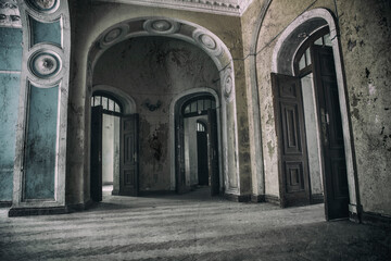 Fototapeta premium A beautiful room with shabby walls in an old abandoned house. Abandoned haunted manor. Ancient architecture and interiors.