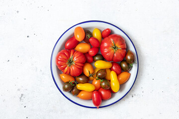 Colored fresh tomatoes in a bowl
