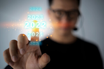 Businessman touching on number 2022