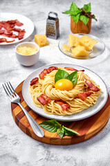 Traditional Italian Pasta Carbonara with bacon, cheese and egg yolk on plate on light background