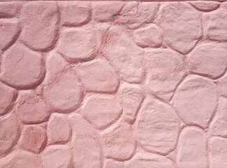 pink cement wall in huge stones, plaster background
