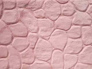 pink cement wall in huge stones, plaster background
