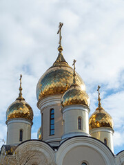Fototapeta na wymiar Close-up of the golden domes of the church. Vertical photo. Religion, Christianity