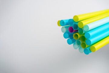 a lot of colorful plastic tubes on a white background. Selective focus, copy space.