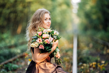 Woman with flowers in dress on blurred background. 
Blurred background and added noise for effect