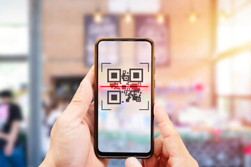 Modified inactive QR Code used. Person scanning QR code with smartphone